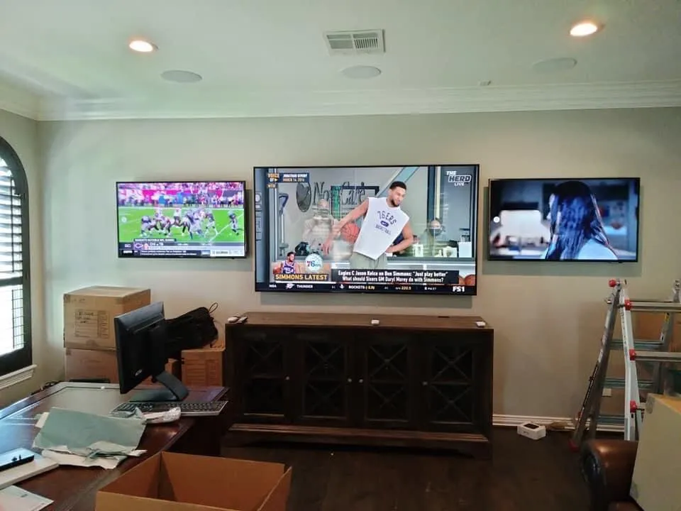 Multiple TVs mounted entertainment room